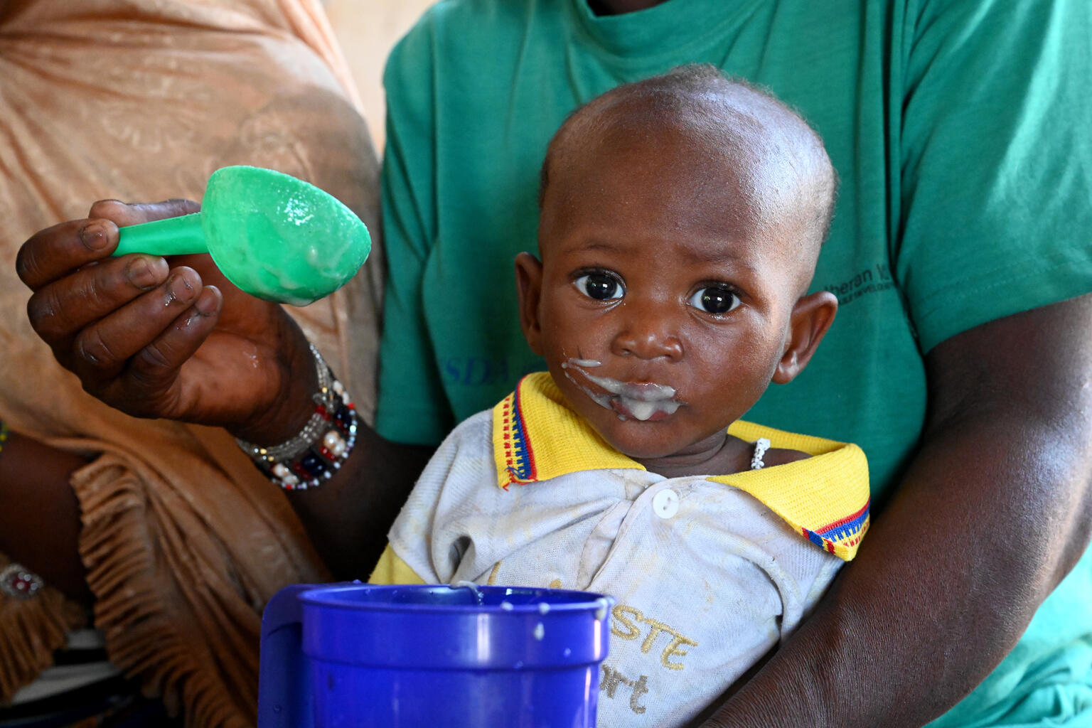 A toddler being fed